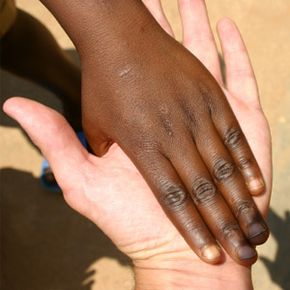 A little one slide his hand over mine while on a recent trip to Rwanda,Africa.