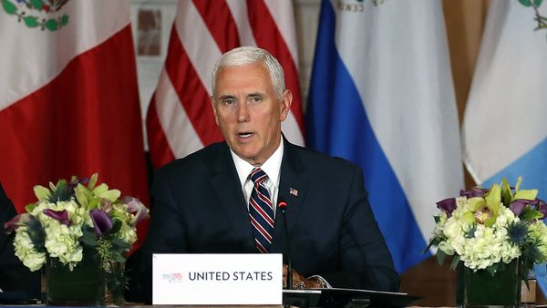 Businessmen in suits, looking at camera, proudly displaying American flag.