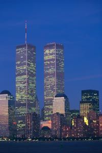 The twin towers as they once stood against the night sky.