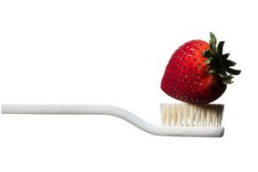 strawberry on top of toothbrush