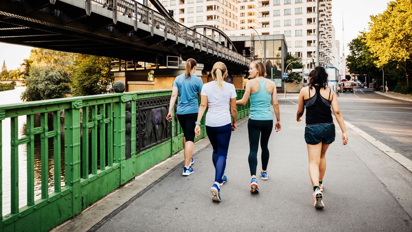 A fitness group for women cooling down after a run through the city together.