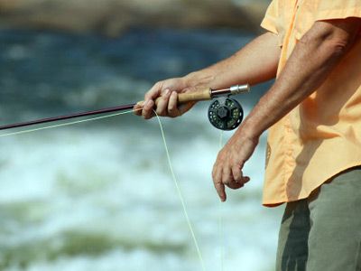 Man holding fishing rod, close-up