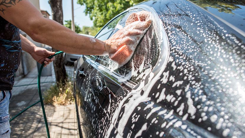 man washing car