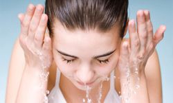 Fresh and lovely woman washing her face