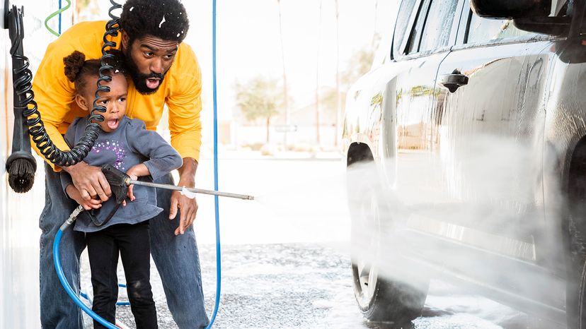 dad and daughter washing car