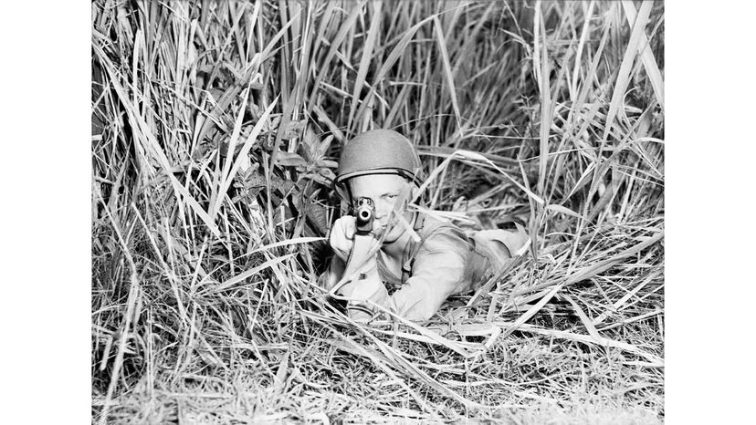 Armed forces battle with rifles in war.