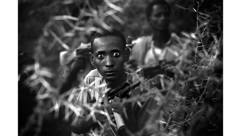 This image from 1980 by Philip Jones Griffith shows a West Somalia Liberation Front fighter in Somalia likely high from consuming 'khat,' a leaf containing an amphetamine-like substance. To compensate for food shortages, the soldiers ate large quantities of khat, which made them undisciplined and easy targets for the enemy. Philip Jones Griffith©/International Center of Photography/Magnum Photos