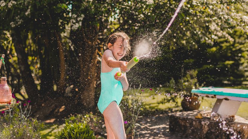 Girl shooting water with toy