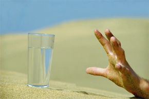 hand reaching for glass of water