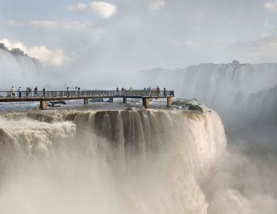 Tourists at Iguacu Falls in Brazil can walk out on a metal platform to see the view.