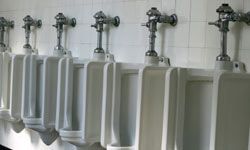 row of traditional urinals