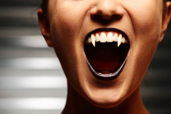 A close up of a vampire woman's mouth.