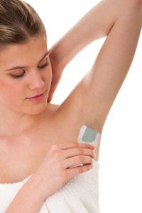 Woman waxing underarm.