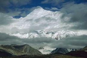 Mount Everest rises up into the upper troposphere. Misty mountain scenes are a common sight since the sudden increase in elevation helps to generate cloud cover.