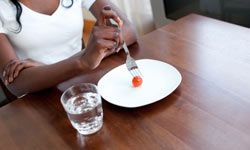 girl eating tomato