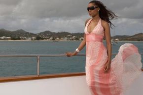 african-american woman wearing long flowing dress on a sailboat