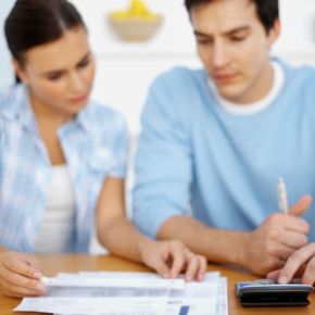 Couple with paperwork and calculator