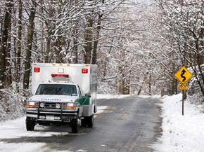 An ambulance races through the snow.