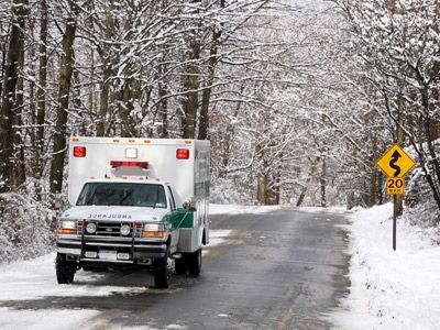 An ambulance races through the snow.