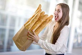 girl consuming loaves of bread