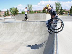 Aaron Fotheringham balances his wheelchair on the lip of a bowl.
