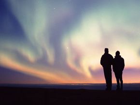 Hikers view the Northern Lights in the Arctic National Wildlife Refuge in Alaska.