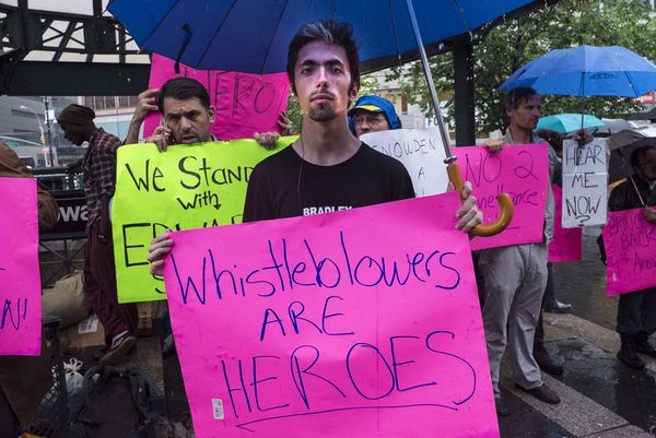 Men protest city life in crowded outdoor crowd.