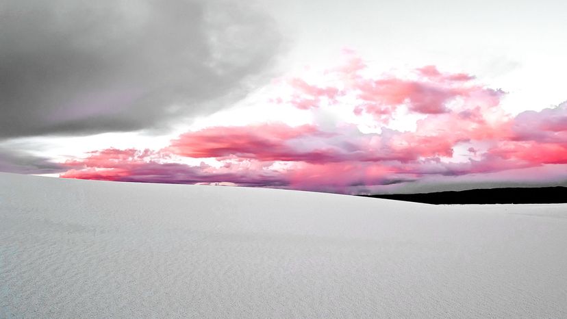 white sand dunes with pink clouds