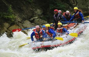 A team of rafters rides out the rapids of the Kicking Horse River in Yoho National Park, British Columbia.
