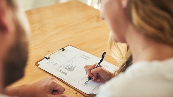 Couple signing a document