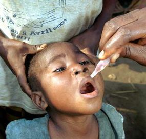 A child receives the polio vaccine in July 2001, near Sibiti, Congo.