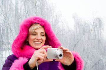 Woman in coat taking pictures