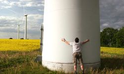guy hugging wind turbine