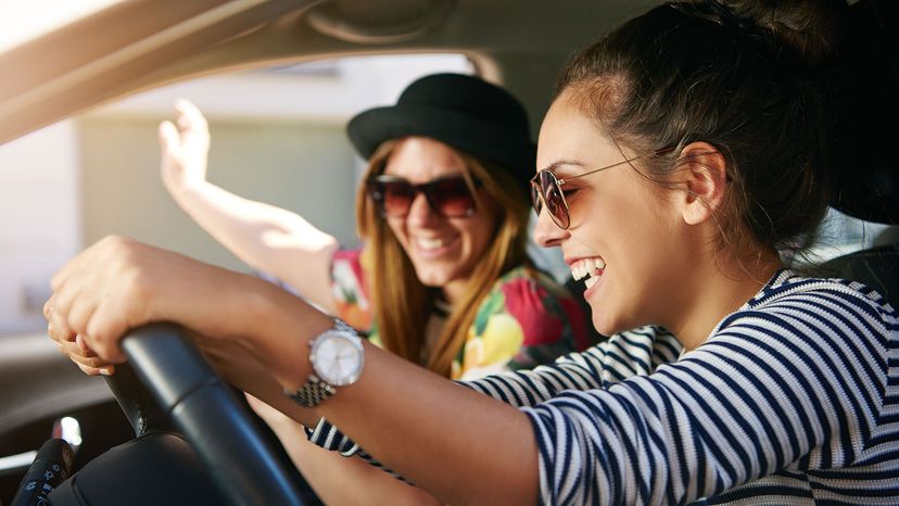 2 girls dirivng with car window open