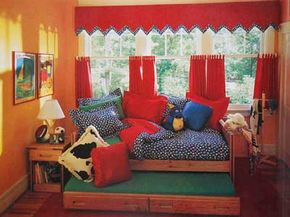 ©This End Up Furniture Co., Inc. A long bank of windows is given a treatment in exciting red. The double-pennantvalance atop the cafe curtains ties the space together by echoing the room's fabric.