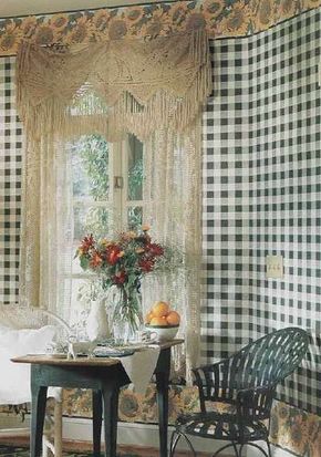 A lacy valance with a pennant bottom adds an antique ambience to this country dining room, softening the crisp black-and-white checks of the walls.