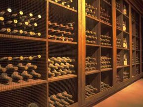 Wine cellar in Napa Valley with plenty of aging, dusty bottles. See more wine pictures.