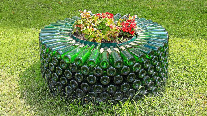 A flower bed made of empty bottles  near the entrance to the champagne factory. Russia, Krasnodar Krai, village of Abrau-Durso, July 19, 2019