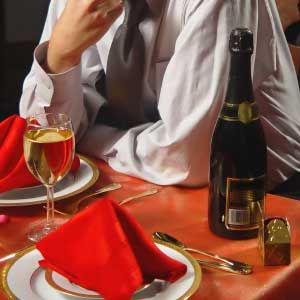 A dinner setting highlighting a bottle of wine.