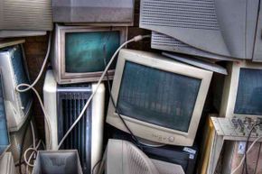 Old computer monitors stacked up.