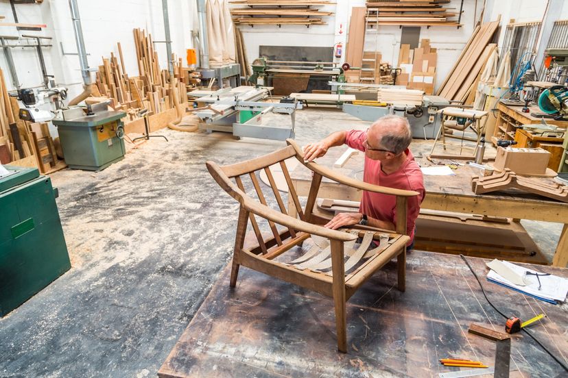 Wood workers creating wooden furniture in wood shop