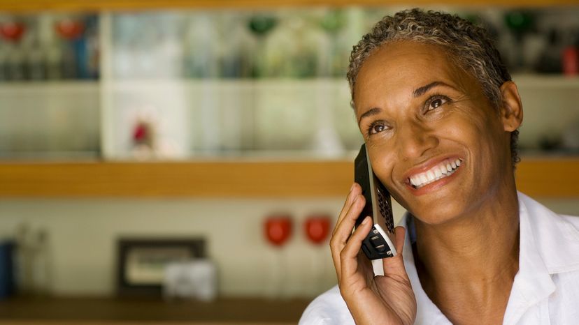 Woman holds cordless phone