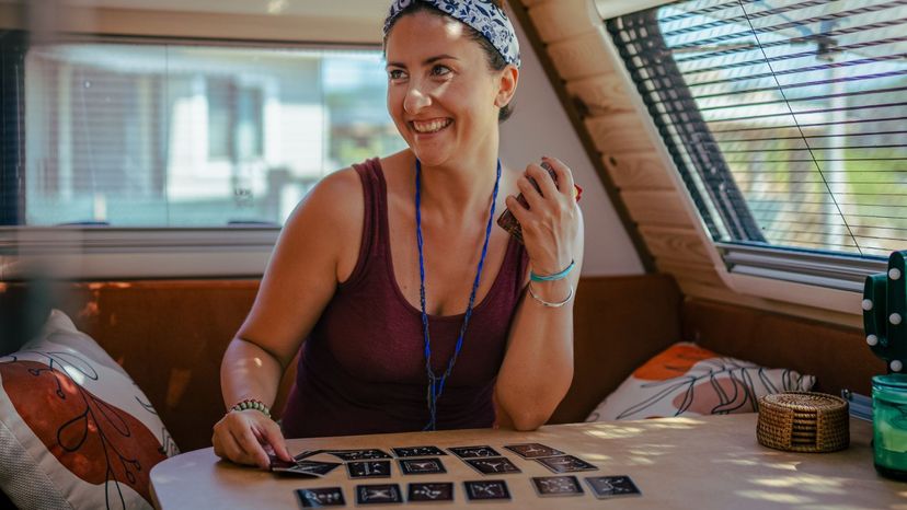 Woman Smiling While Playing Tarot
