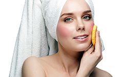 Woman cleaning face after showering