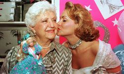 Barbie creator Ruth Handler gets a kiss at her creation's birthday celebration.