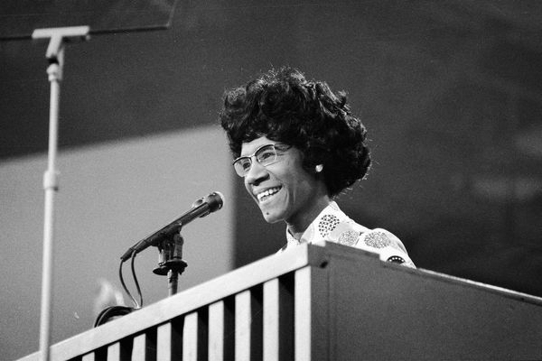 African American educator and U.S. Congresswoman Shirley Chisholm speaks at a podium at the Democratic National Convention in July 1972.