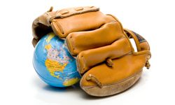 small globe of the world in baseball mitt