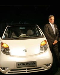 Ratan Tata poses in front of the Nano during its launch in New Delhi, India.