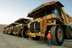 Maintenance foreman Gary Frost inspects huge dump trucks before they start the day at Barrick's Ruby Hill Mine outside Eureka, Nev., in 2006. They're definitely big, but these aren't the biggest mining trucks in use. See more pictures of trucks.