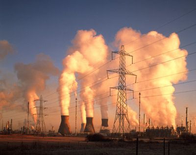 A petrochemical plant spews flue gas at dawn.